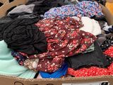 a cardboard box filled with clothing and other items