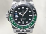 a rolex watch with a green bezel on the bracelet