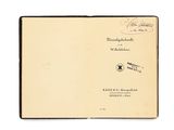 an open book with a handwritten title on the cover