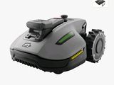 a robotic lawn mower that is sitting on a white surface
