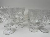 several empty wine glasses are lined up on a table