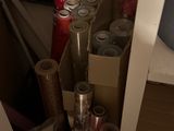 many rolls of wrapping paper and other items in the closet