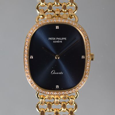 an image of a close up of a wrist watch with a chain around it