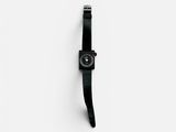 black watch on a white surface with a white background