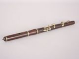 a wooden flute with a brass band on it