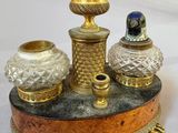 a gold and silver candle holder on a marble base