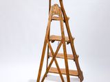 a wooden ladder that is standing up against a white background