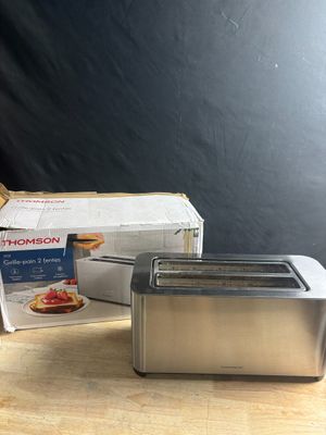 a toaster that is sitting on a table next to a box
