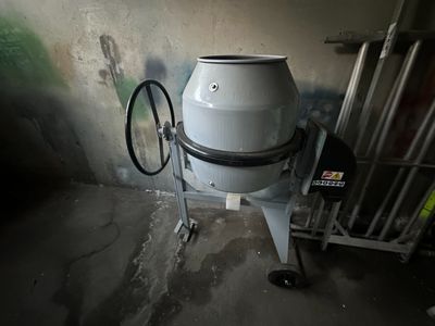 a large white drum sitting on a cart in a room