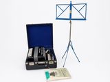 a suitcase that has a music stand and a book in it