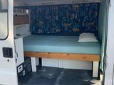 a white van with a bed in the back of it