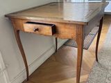 a wooden table with a drawer underneath it