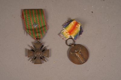 two medals and a medal sitting on a table