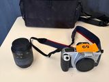 a camera and a lens on a table next to a camera bag