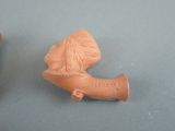 two clay figurines of a man and a woman