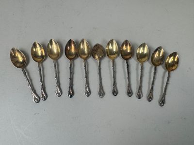 six spoons are lined up in a row on a table
