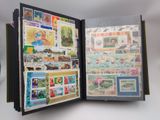 an open book with stamps on it on a table