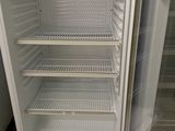 a white refrigerator that is open in a room