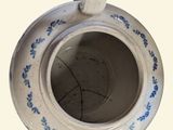 a white and blue cup with a handle on it
