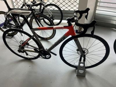 many bikes that are parked in a room together