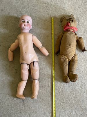 two dolls that are next to each other on the floor