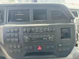 a dashboard of a car with a radio and a steering wheel