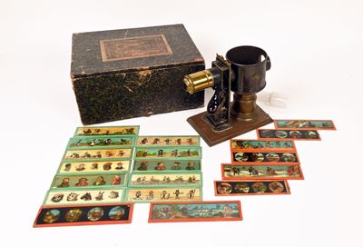a box of cards with pictures on it next to an old sewing machine