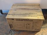 a box that is sitting on the floor next to a refrigerator