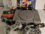 a video game system sitting on a table next to other items