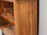 a wooden cabinet with a drawer on top of it