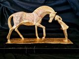 statue of a horse and a woman on a black background