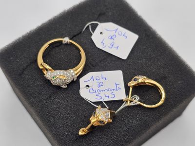 deux bagues en or serties de diamants et une étiquette posée sur le couvercle d'une boîte