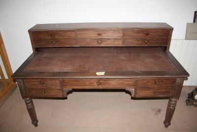 a wooden desk with a drawer on top of it