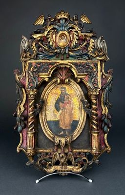 an old picture frame with a picture of a man holding a cross