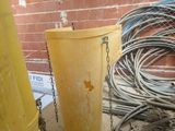 a yellow trash can sitting next to a yellow trash can