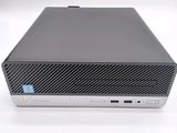 the back of a small computer with a keyboard on top of it