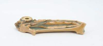 a small ceramic object that is on a white surface
