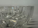 a clear glass bowl with a flower inside of it