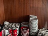 many cups and saucers sitting on a table