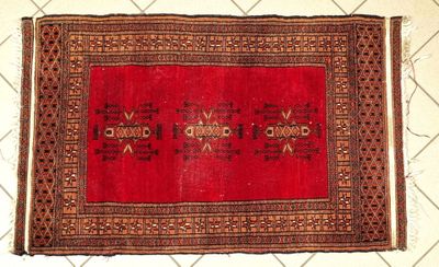 rug on the floor is red and brown with a design on it