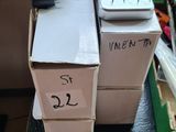 two boxes with remotes on top of them on a table