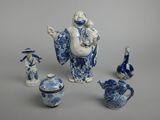 a group of blue and white porcelain figurines and vases