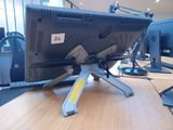 a computer monitor sitting on top of a wooden desk