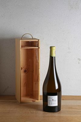 a bottle of wine sitting next to a wooden box