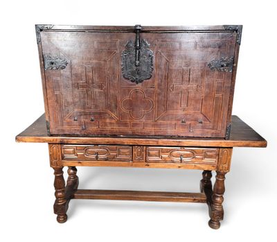 an old wooden chest sitting on top of a table next to a wooden table