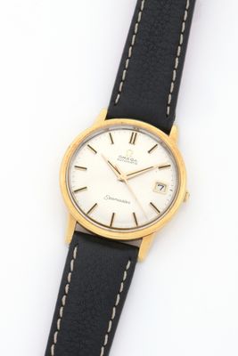 a close up of a watch on a white surface with a black strap