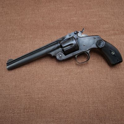 a close up of a revolver on a brown background