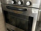stainless steel oven with pots and pans on top of it in a kitchen