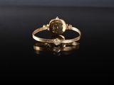 a close up of a gold ring on a black surface