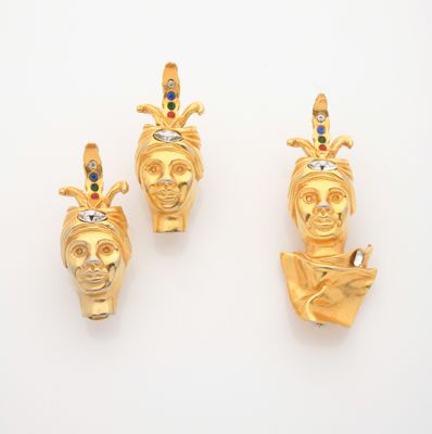 three gold - plated figurines of a woman and a man
